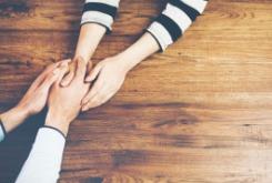 people holding hands on a table